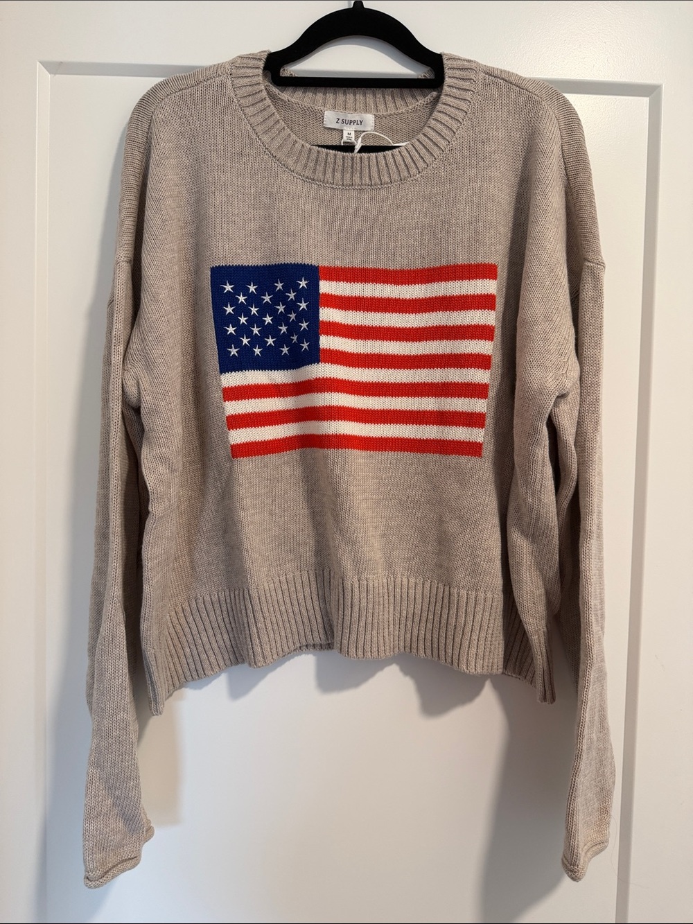 Z Supply Beige Crewneck Sweater with Red & Blue Flag Graphic